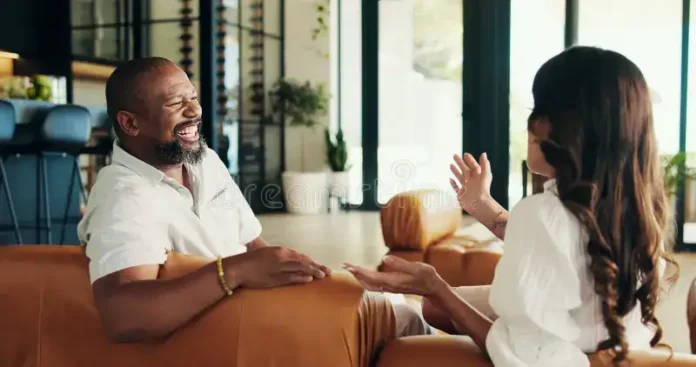 Couple talking and laughing together, sharing gossip and bonding in their relationship
